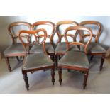 A Set Of Five Victorian Mahogany Balloon Back Dining Chairs with carved rail backs, above drop in