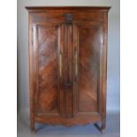 An 18th Century French Oak Armoire, the moulded cornice above a rosette carved frieze and two