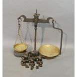 A Set Of Wrought Iron And Brass Balance Scales, together with a set of ten weights in the form of