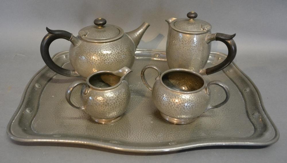 A Tudric Pewter Four Piece Tea Service, together with a Warric beaten pewter tray with Cricket