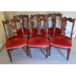 A Set of Six Victorian Walnut Dining Room Chairs, each with a carved shaped back above a stuff