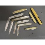 A Silver Bladed Mother Of Pearl Folding Fruit Knife, together with three similar fruit knives and