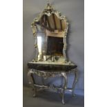 A French Silvered Console Table with a large shaped mirror above a marble top, the base with a
