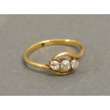 An 18 ct. Yellow Gold Three Stone Diamond Crossover Ring