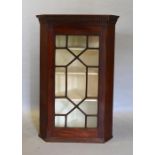 A Mahogany Hanging Corner Cabinet With An Astragal Glazed Door enclosing shelves
