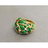 A Yellow Metal Dress Ring With Green Enamel Interspaced With Diamonds