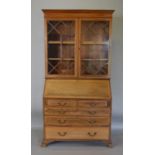 An Edwardian Mahogany Satinwood Inlaid Bureau Bookcase the moulded cornice above two astragal glazed