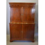 A 19th Century Mahogany Press Cupboard the moulded cornice above four panel doors, raised upon