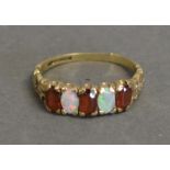 A 9 ct. Opal And Garnet Set Ring With Two Opals And Three Garnets, within a pierced setting