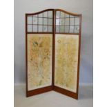 A 19th Century Mahogany Two Fold Screen, the sectional lead glazed top above silk work foliate