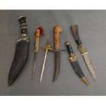 A Small Khukri Knife Together With Five Other Small Knives and a letter opener