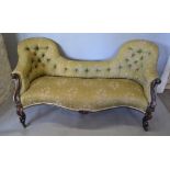 A Victorian Rose Wood Double Spoon Back Serpentine Settee with a button upholstered back and stuff