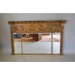 A Regency Gilded Over Mantle Mirror With A Ball Cornice above a relief decorated frieze with