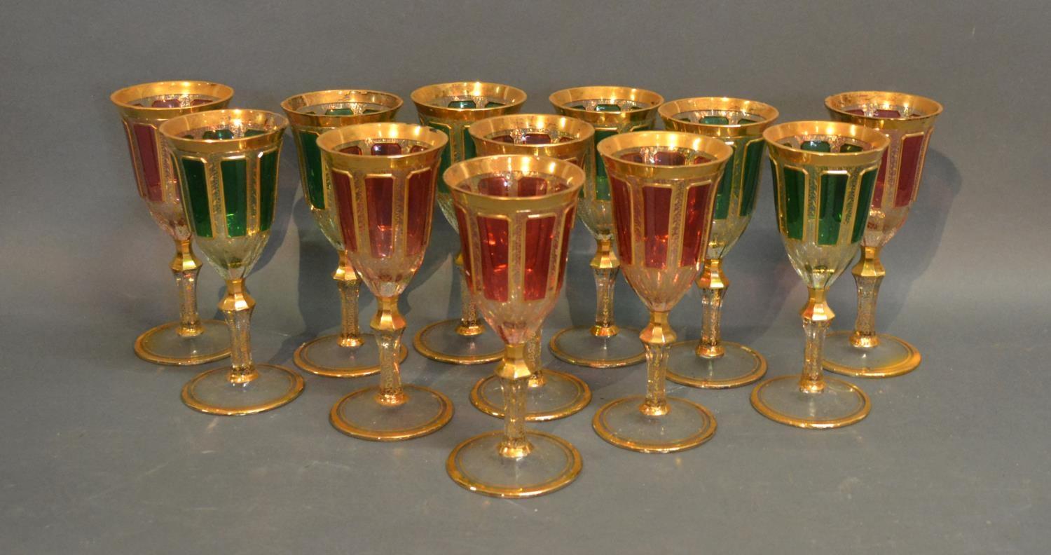 A Set Of Twelve Coloured Wine Glasses Highlighted With Gilt