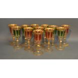 A Set Of Twelve Coloured Wine Glasses Highlighted With Gilt