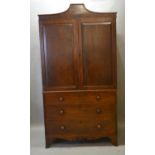 A 19th Century Mahogany Linen Press, the shaped cornice above two panelled doors with sliding trays,