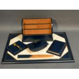 A Blue Leather Desk Set Comprising Blotter, Notebook, Stationery, Stand and other items
