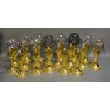 A Collection Of Nineteen Brass Candlesticks Some With Glass Shades