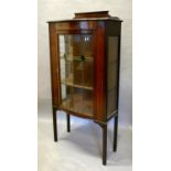 An Edwardian Mahogany Painted And Inlaid Display Cabinet with a semi-bow fronted lead glazed door,