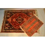 A North West Persian Woollen Rug With A Central Medallion within an all over design upon a red,