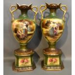 A Pair Of Victorian Two Handled Vases Decorated With Figures within landscapes highlighted with