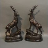A Pair Of Patinated Bronze Models In The Form Of Stags upon oval marble plints, 44cm tall