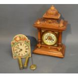 A Walnut Cased Mantel Clock With Enamel Dial, together with a German painted dial wall clock