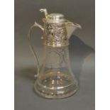 An Etched Glass And Silver Plated Claret Jug With Embossed Decoration and shaped handle, 25cm tall
