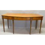 A Regency Mahogany Bow Fronted Serving Table, the reeded top above a central drawer flanked by dummy