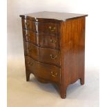 A 20th Century Mahogany Serpentine Chest Of Four Drawers with brass handles, raised upon out swept