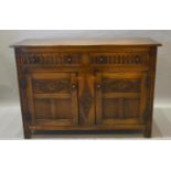A 20th Century Oak Dresser Base With Two Drawers above two carved panel doors, flanked by stiles,
