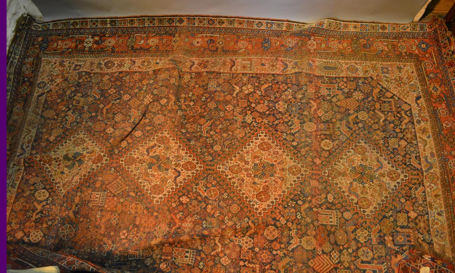 A North West Persian Woollen Carpet With Four Central Medallions within an all over design upon a