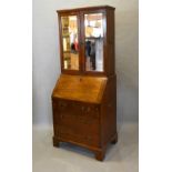 A George III Mahogany Bureau Bookcase The Moulded Cornice above two mirrored doors enclosing shelves