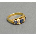 A 9ct. Gold Sapphire And Diamond Ring, three sapphires inter-spaced with diamonds within a pierced