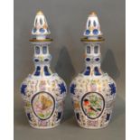 A Pair Of Bohemian Cameo Glass Decanters With Stoppers decorated in polychrome enamels with reserves