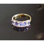 A Yellow Gold Tanzanite Five Stone Ring Claw Set