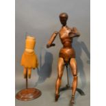 A 19th Century French Carved Wooden Artists Mannequin With Stand, together with a similar carved