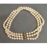 A Triple Row Cultured Pearl Choker With A Triple Sapphire and Diamond cluster clasp in gold