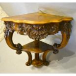 A Victorian Carved Walnut Corner Table The Shaped Moulded Top above a shell carved frieze, raised