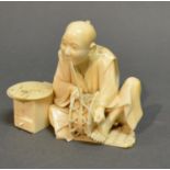 A Meiji Period Japanese Carved Model In The Form Of A Tradesman, with seal mark to base, 7cm tall