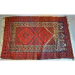 A North West Persian Woollen Rug With An All Over Design upon a red, blue and cream ground within