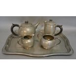 A Tudric Pewter Four Piece Tea Service, together with a Warric beaten pewter tray with Cricket
