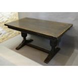 An Early 20th Century Oak Draw Leaf Refectory Style Dining Table the plank top above a carved