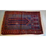 A Baluchi Woollen Prayer Rug With An All Over Design upon a blue, red and cream ground within