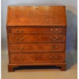 A George III Oak Bureau The Fall Front Enclosing A Fitted Interior above four long graduated drawers