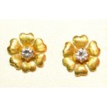 A Pair Of 18ct. Gold Solitaire Diamond Set Ear Studs Of Flower Head Form