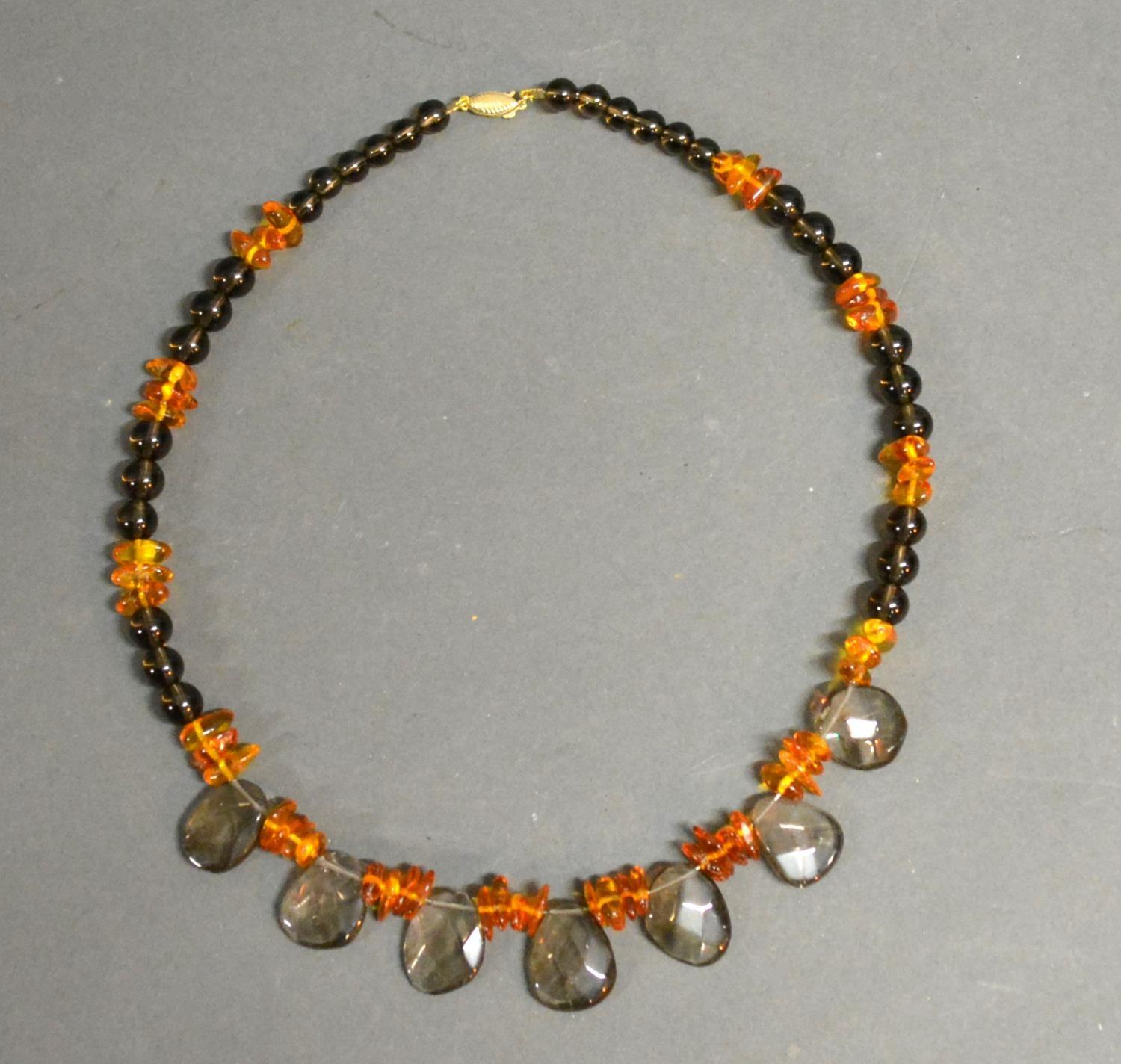 A Quartz And Amber Necklace With 9ct. Gold Clasp