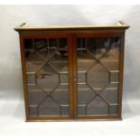 A 19th Century Mahogany Bookcase The Moulded Cornice above two astragal glazed doors enclosing