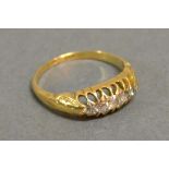 An 18ct. Yellow Gold Five Stone Diamond Ring with five graduated stones within a pierced setting