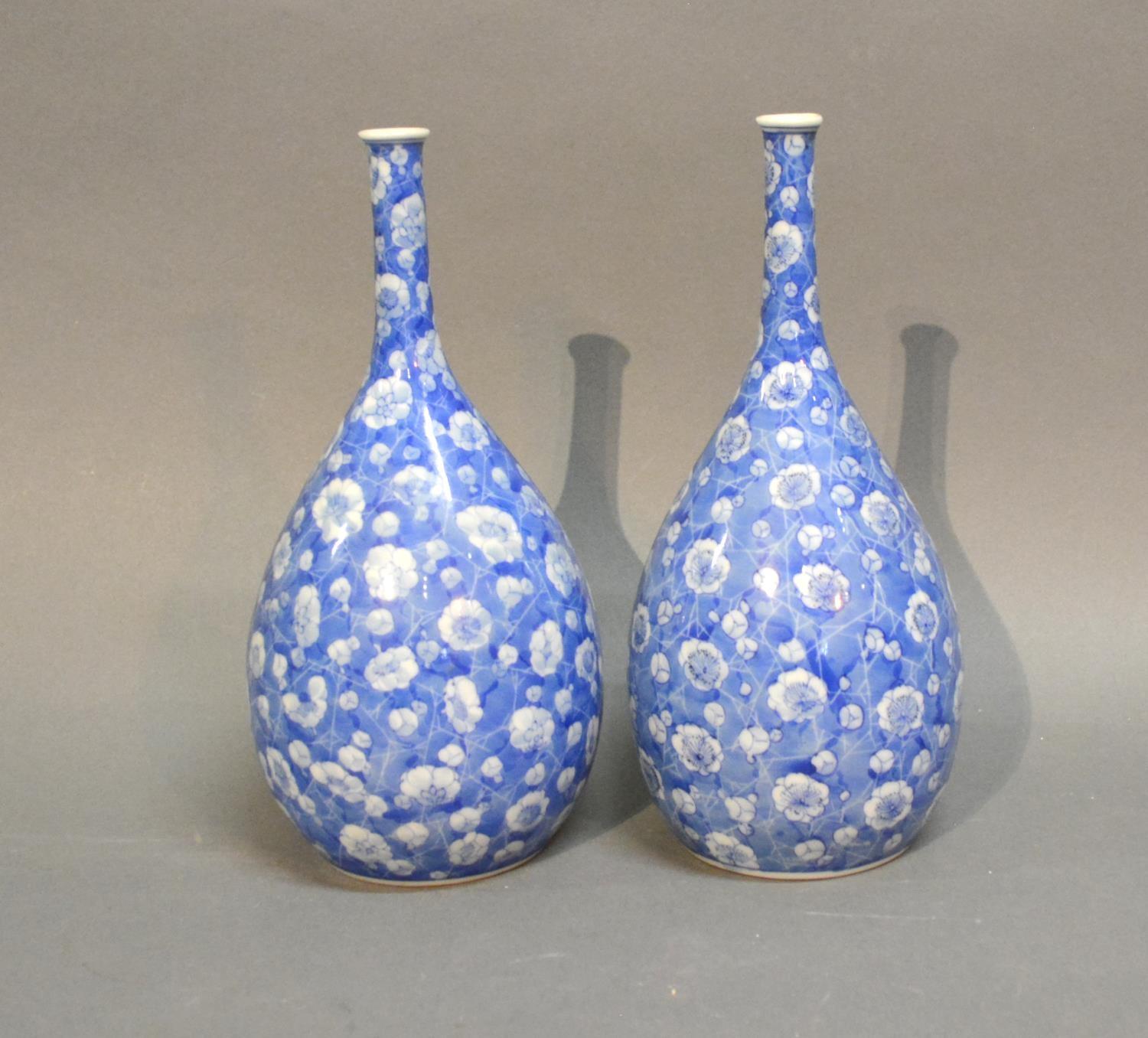 A Pair Of Japanese Under Glazed Blue Decorated Bottle Neck Vases of Oviform, 24cm tall